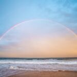 rainbow over rippling sea in nature